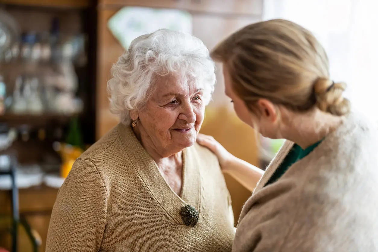Woman talking to elderly woman