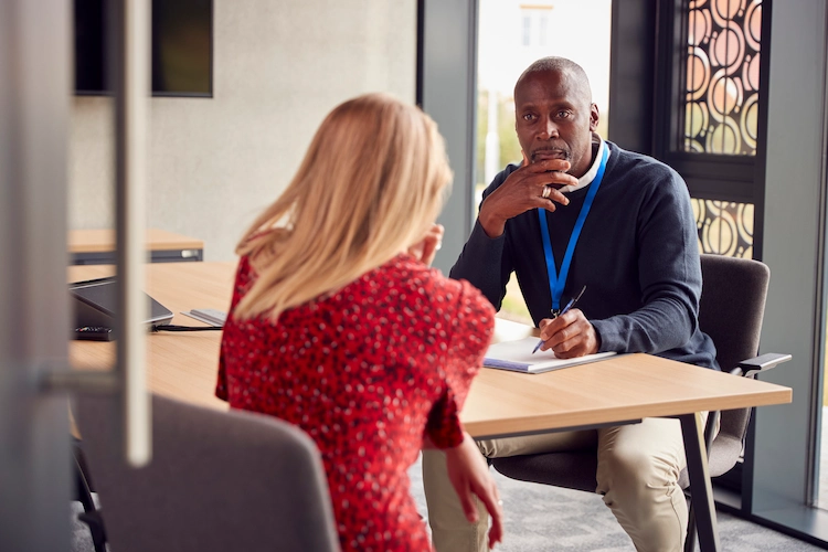 A counselling meeting between two people in an office