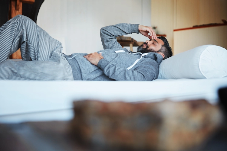 a man lying down with a headache