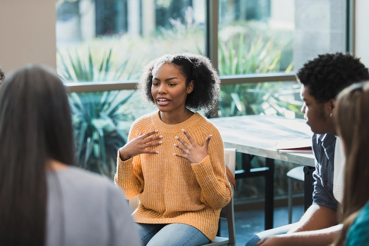 young girl talking in group therapy