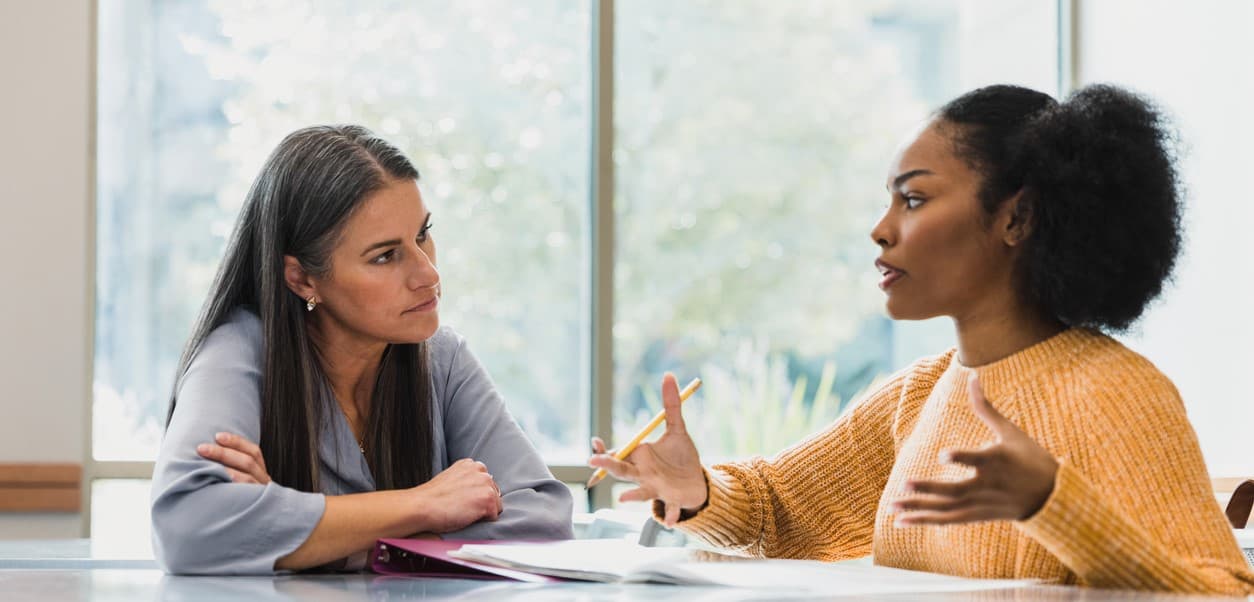 Two people discussing rehab options