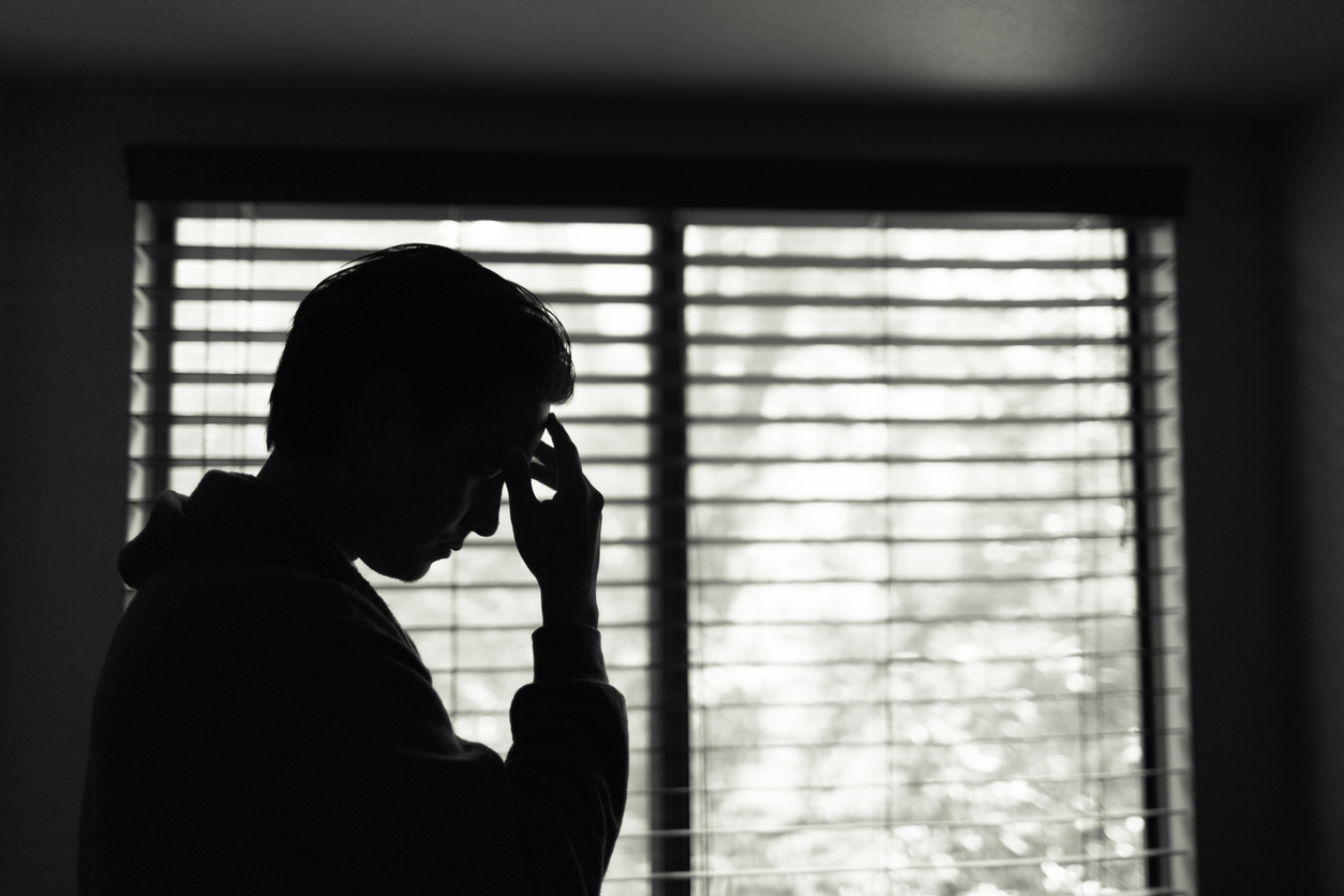 Substance Abuse and Suicide - an image of a man looking tired and stressed.