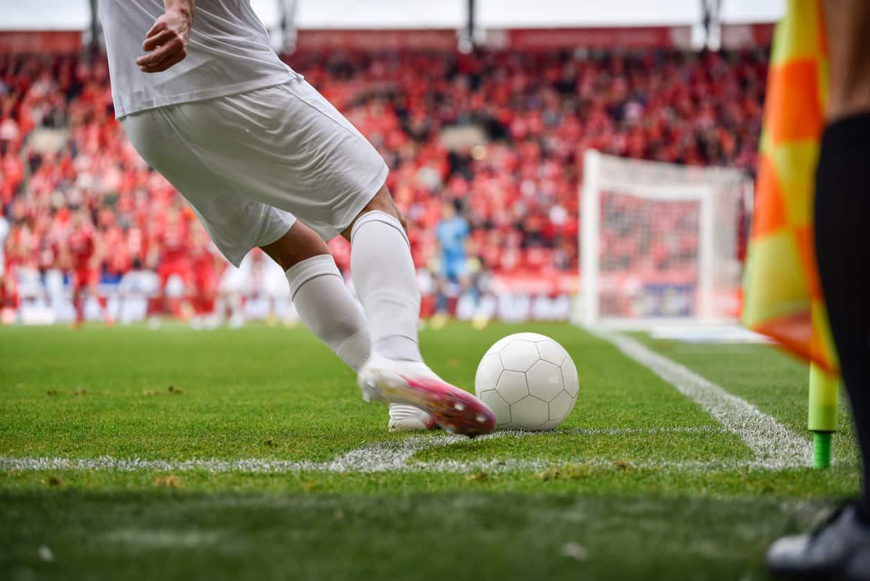 Footballer kicking a football